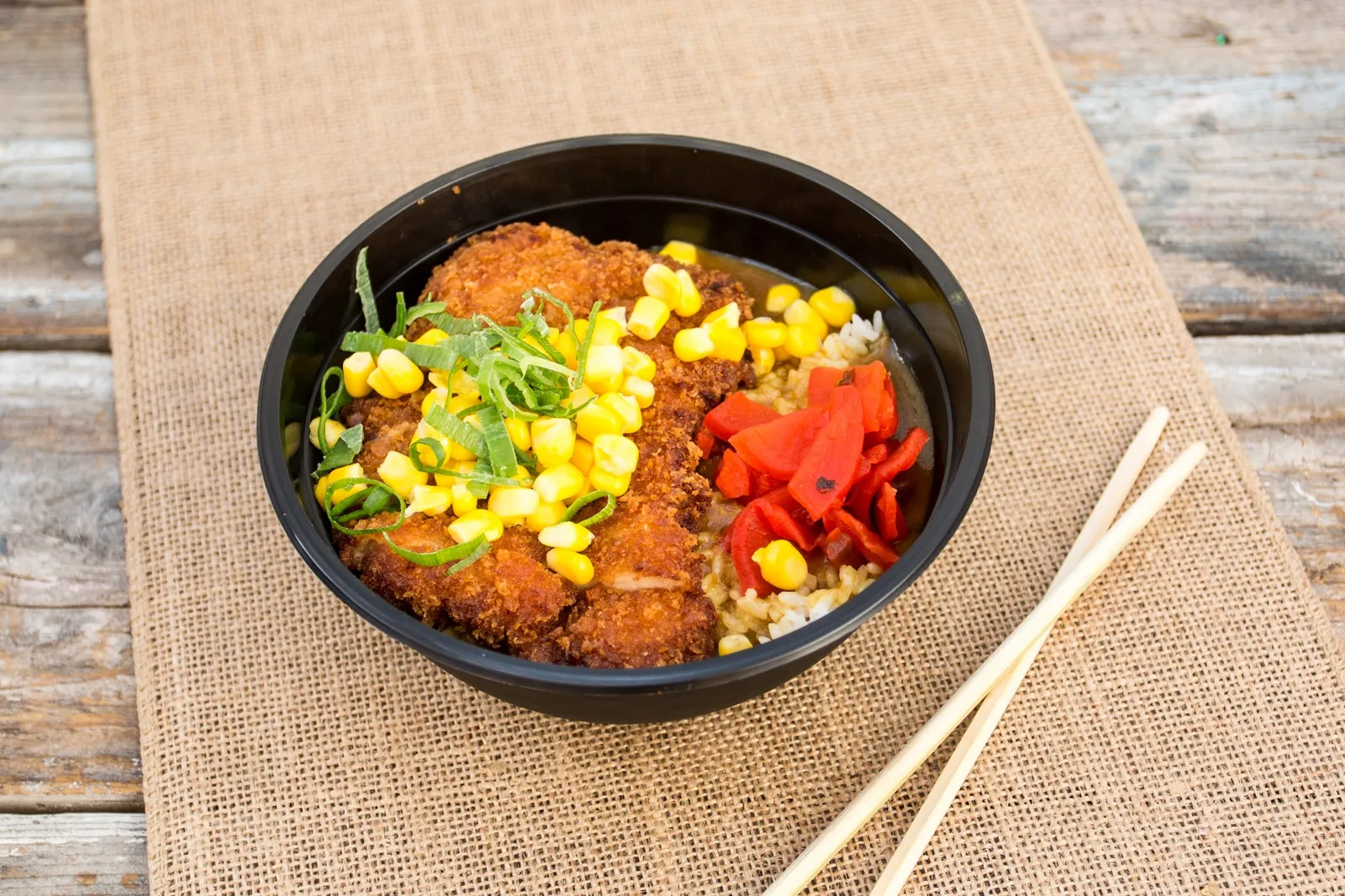 Katsu chicken rice bowl with corn, spring onion and pickled ginger